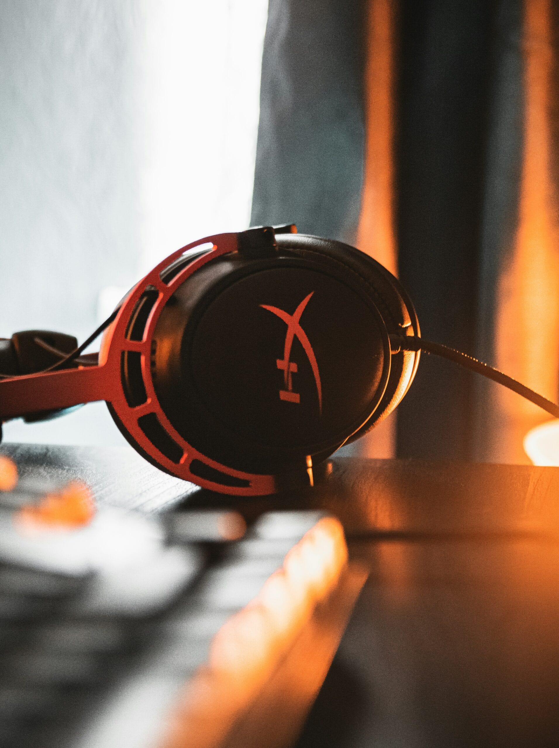 black and red headphones on brown wooden table